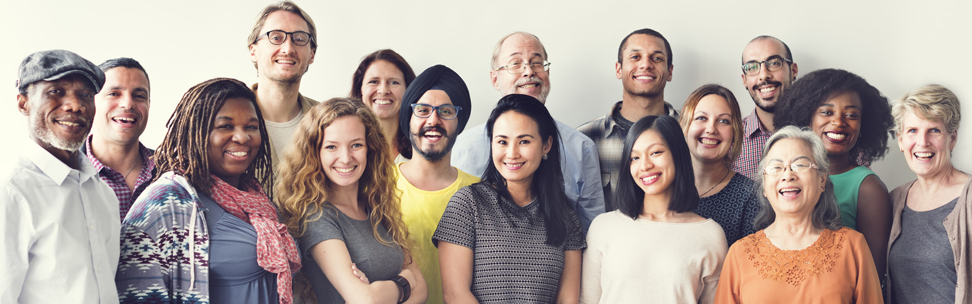 a group of diverse individuals smile while looking straight ahead