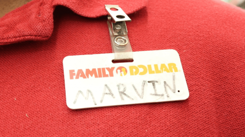 Close up photo to a red polo shirt and employee "Family Dollar" badge that reads "Marvin"
