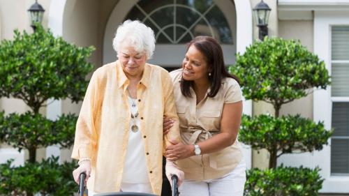 caregiver helps older woman