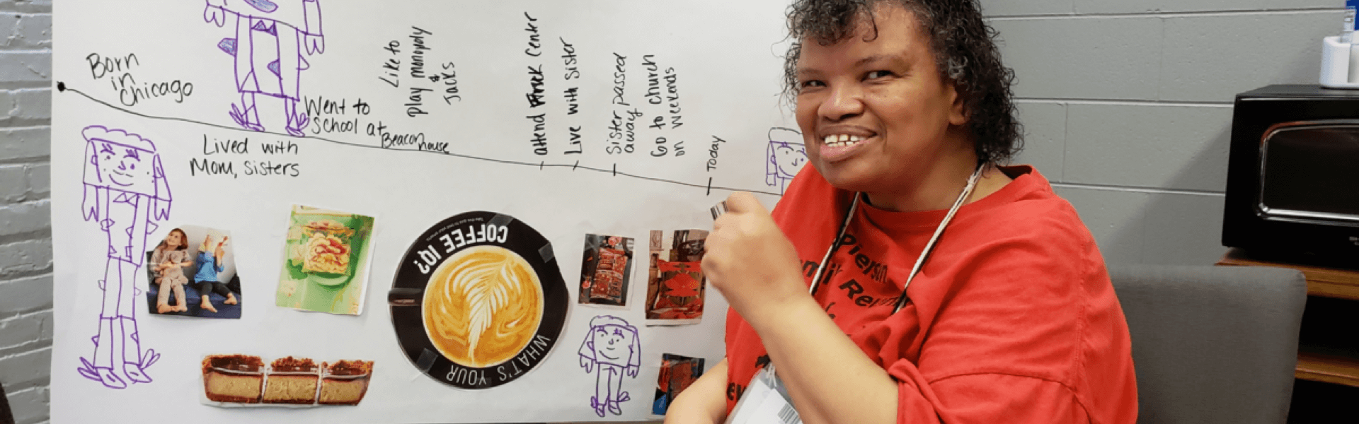 Woman of color sitting in front of a timeline, wearing a red t-shirt and smiling