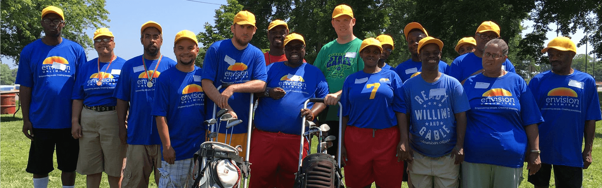 Team photo with each player wearing a bright yellow had and royal blue t-shirt