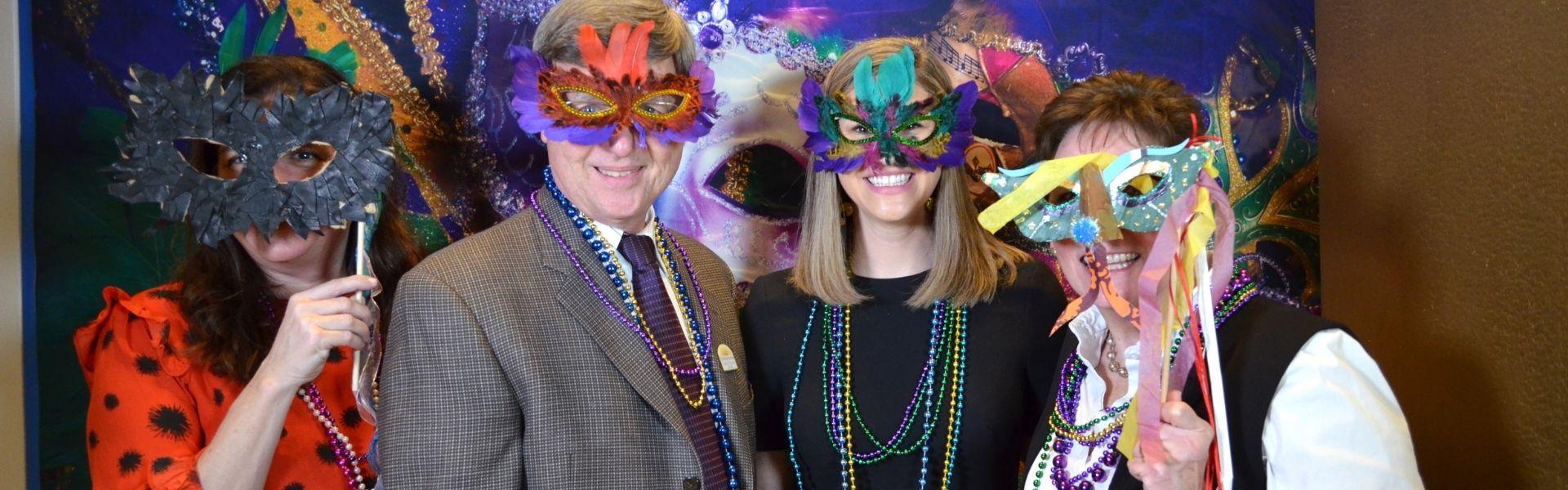 EnVisionaries posing with Mardi Gras masks