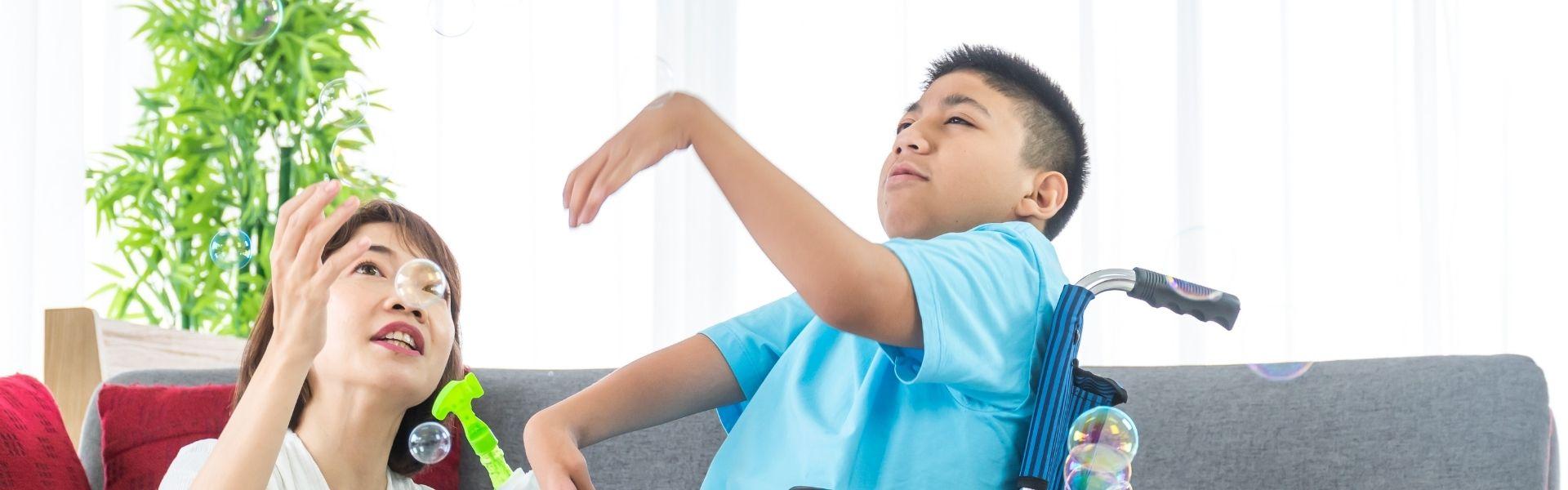 Woman and boy blow bubbles