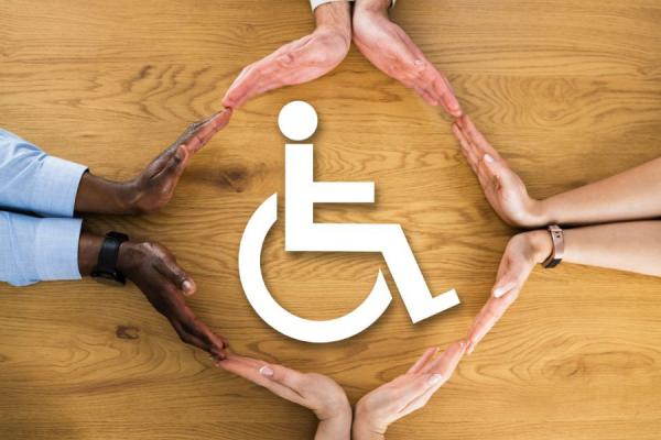 Accessibility symbol surrounded by racially diverse hands