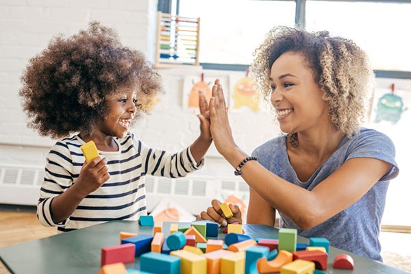 Toddler and mother playing together. Image by Weekend Images Inc.