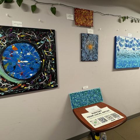 A group of paintings on a wall.