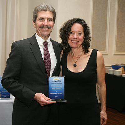 Jenny Achuthan receives the 2023 Volunteer of the Year Award from Envision Unlimited President and CEO Mark McHugh during a November awards dinner.