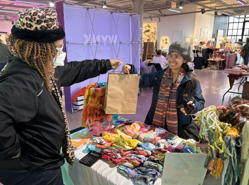 Lucy making a sale at one of last year's holiday markets.